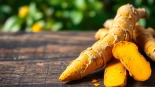 Healthy Turmeric Root on a wooden table showcasing its vibrant colors and textures.