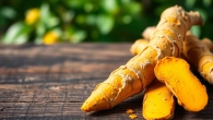 Healthy Turmeric Root on a wooden table showcasing its vibrant colors and textures.