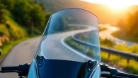View of motorcycle windshields showcasing sleek design and high clarity against natural scenery.