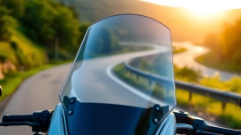 View of motorcycle windshields showcasing sleek design and high clarity against natural scenery.