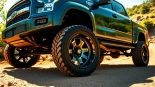 Showcase of XD wheels on a rugged truck in an off-road setting with vibrant natural lighting.