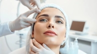 Facial balancing treatment enhancing facial features of a model in a bright clinic.