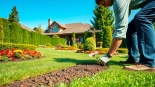 Landscaping contractor Coquitlam preparing vibrant flowerbeds in a lush residential garden.