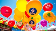 Print balloons with your logo displayed in a lively outdoor celebration setting.