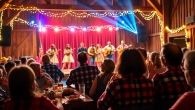 Experience the vibrant atmosphere at Firelight Barn Dinner Theater with lively performances and BBQ.