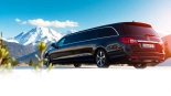 Experience premium car service YVR to Whistler with a luxurious limousine against stunning mountains.