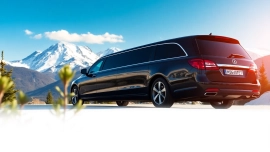 Experience premium car service YVR to Whistler with a luxurious limousine against stunning mountains.